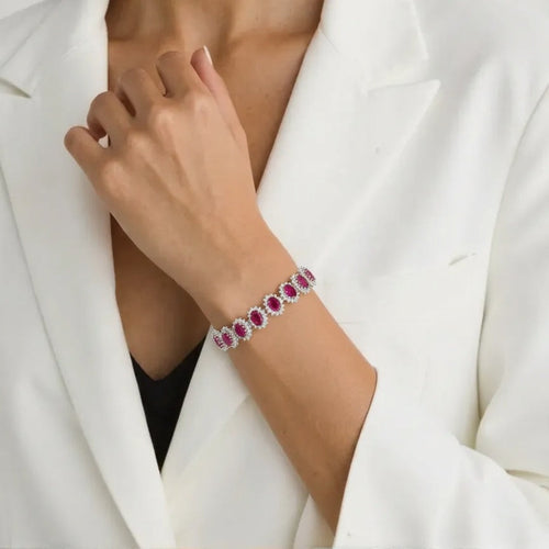 Bracelet with red gemstones on a person wearing a white blazer