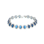 Silver bracelet with blue gemstones on a white background